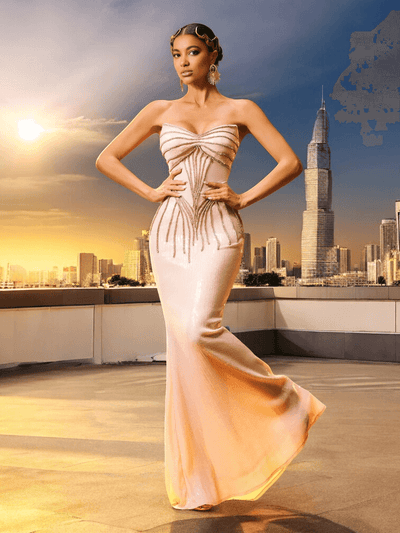Beige strapless sequin maxi dress with full-length sparkle, fitted silhouette, and elegant evening gown design