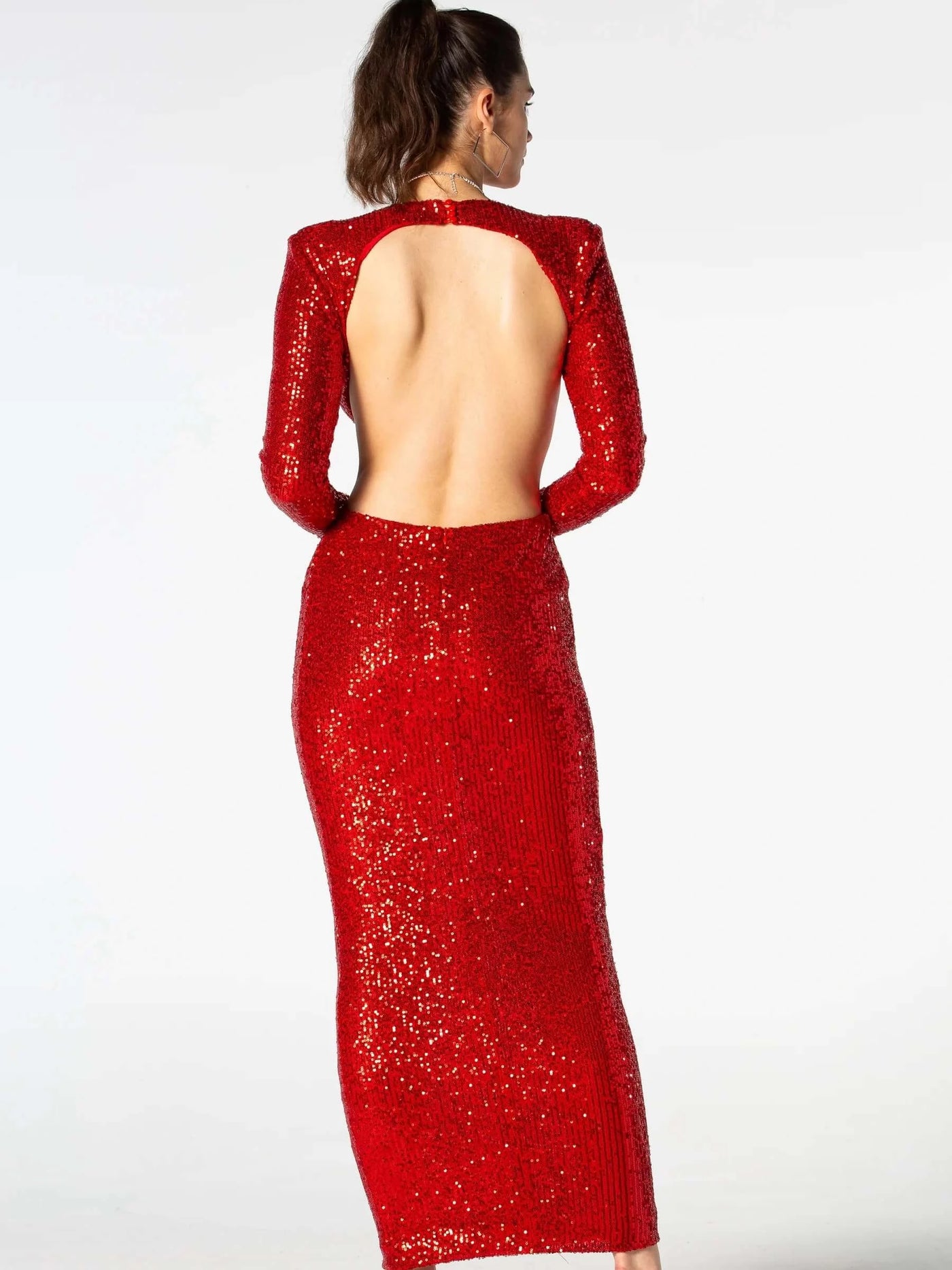 Stunning maxi dress adorned with sequin embellishments and featuring stylish cut-out details.