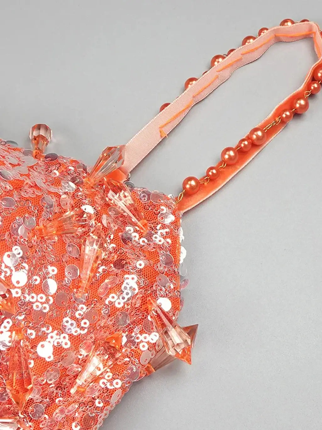 Flowing orange maxi dress from Noura Couture adorned with pearls