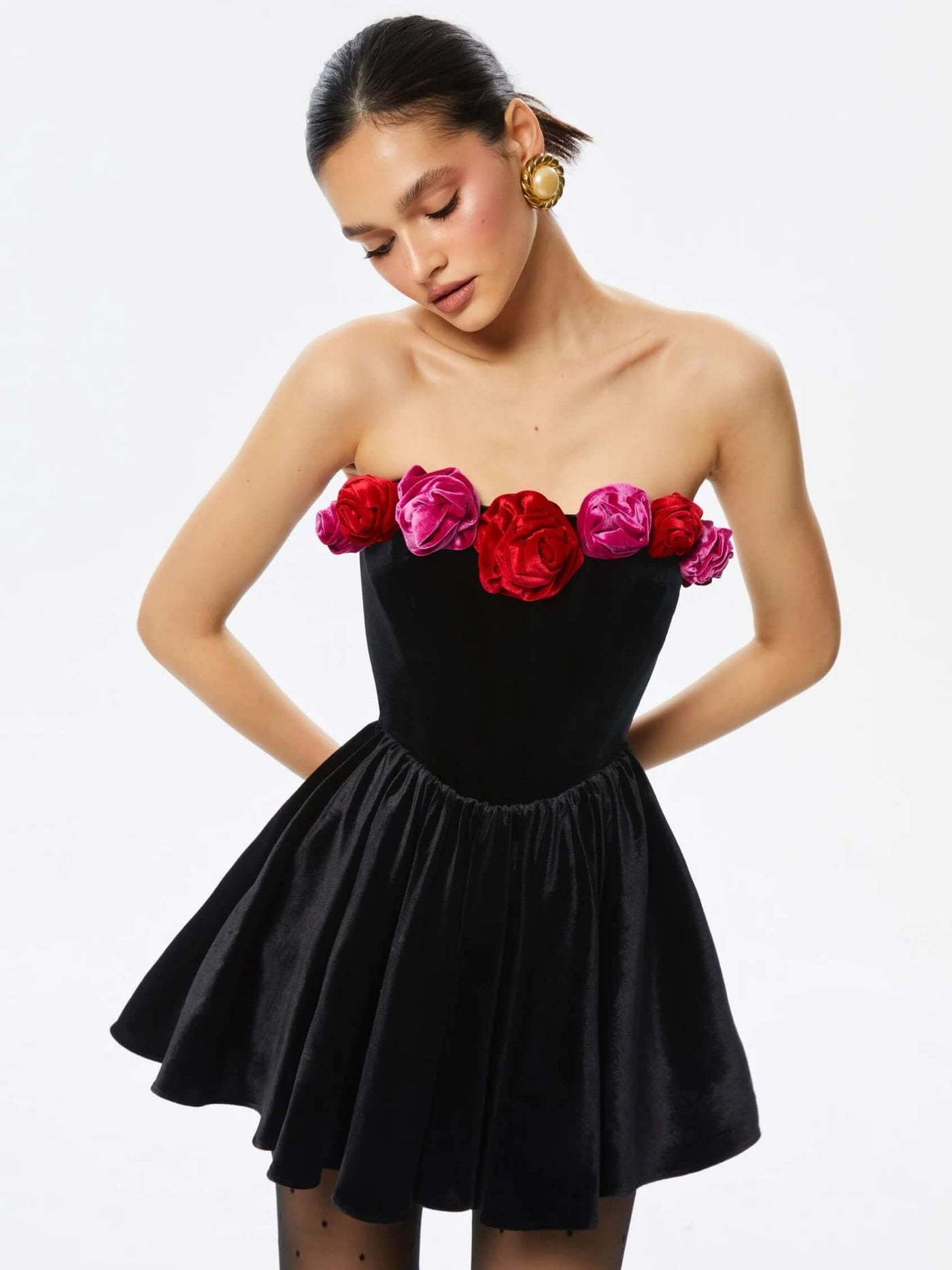 Black halter dress with cutout flower details adorned with sequins