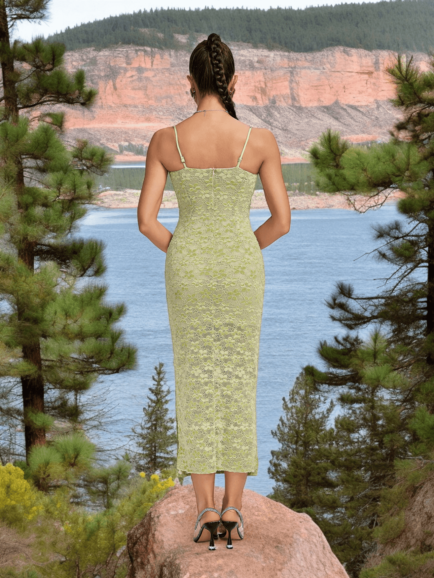 Woman wearing Crystal Bustier Lace Midi Dress Green, standing on rock with lake and forest background