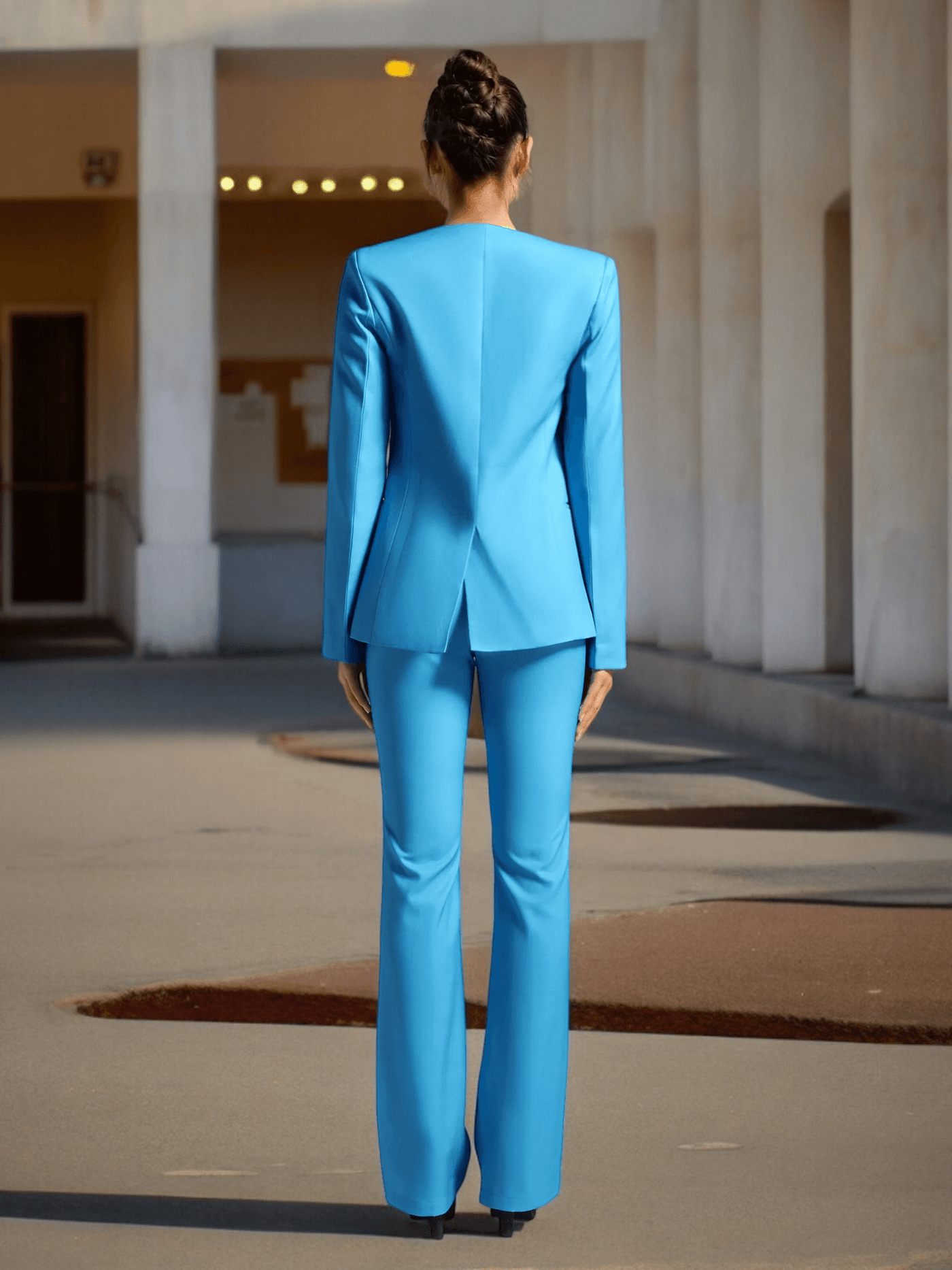 Woman wearing blue Flower Blazer Set from behind showing elegant floral design and high-quality fabric.