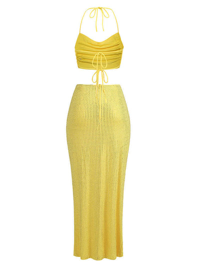 Yellow two-piece maxi dress with halter neckline and embellishments