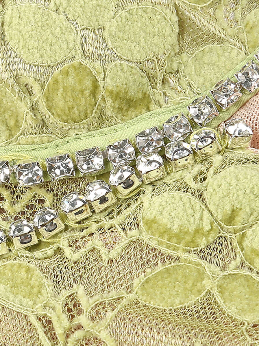 Close-up of crystal detailing on the green lace fabric of the Crystal Bustier Lace Midi Dress by Valensia Seven