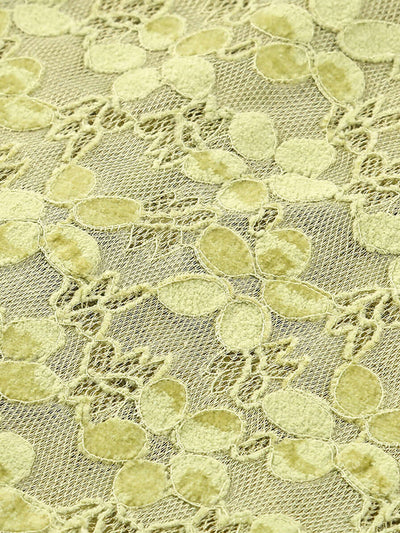 Close-up view of green lace fabric from the Crystal Bustier Lace Midi Dress Green with intricate floral patterns.