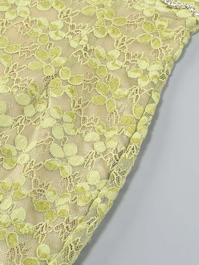Close-up of green lace fabric on the Crystal Bustier Lace Midi Dress, highlighting intricate floral patterns and crystal detailing