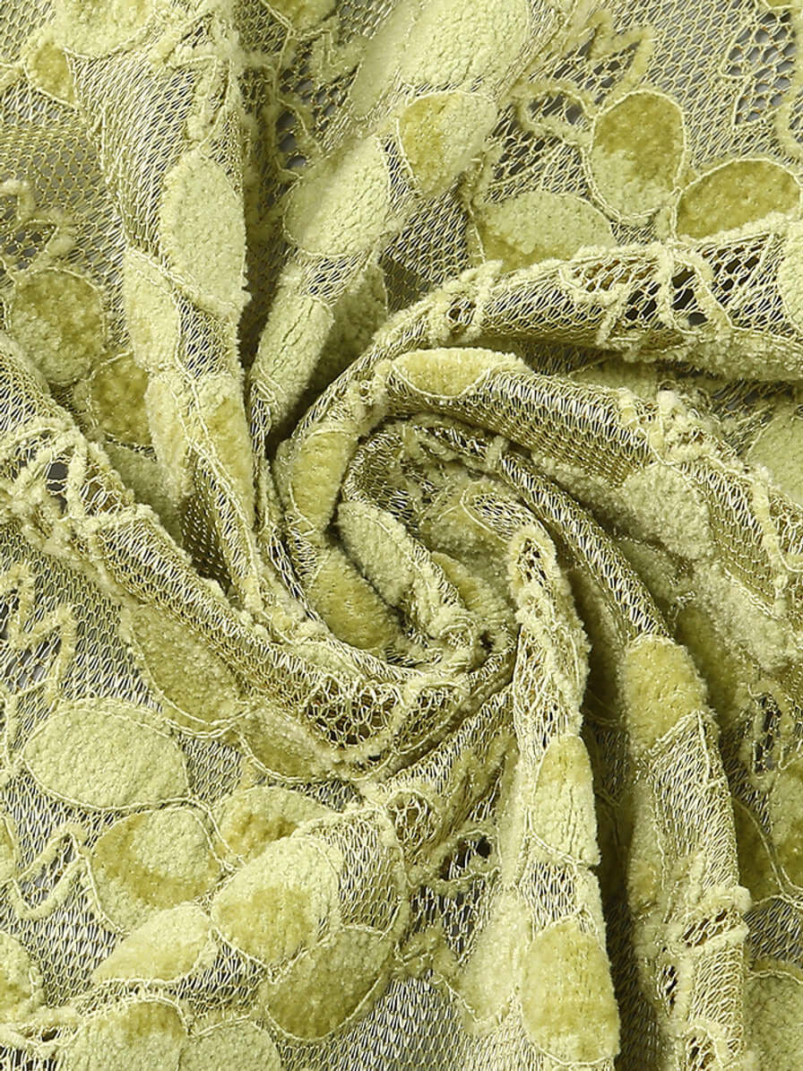 Close-up of green lace fabric with intricate crystal detailing from the Crystal Bustier Lace Midi Dress Green.
