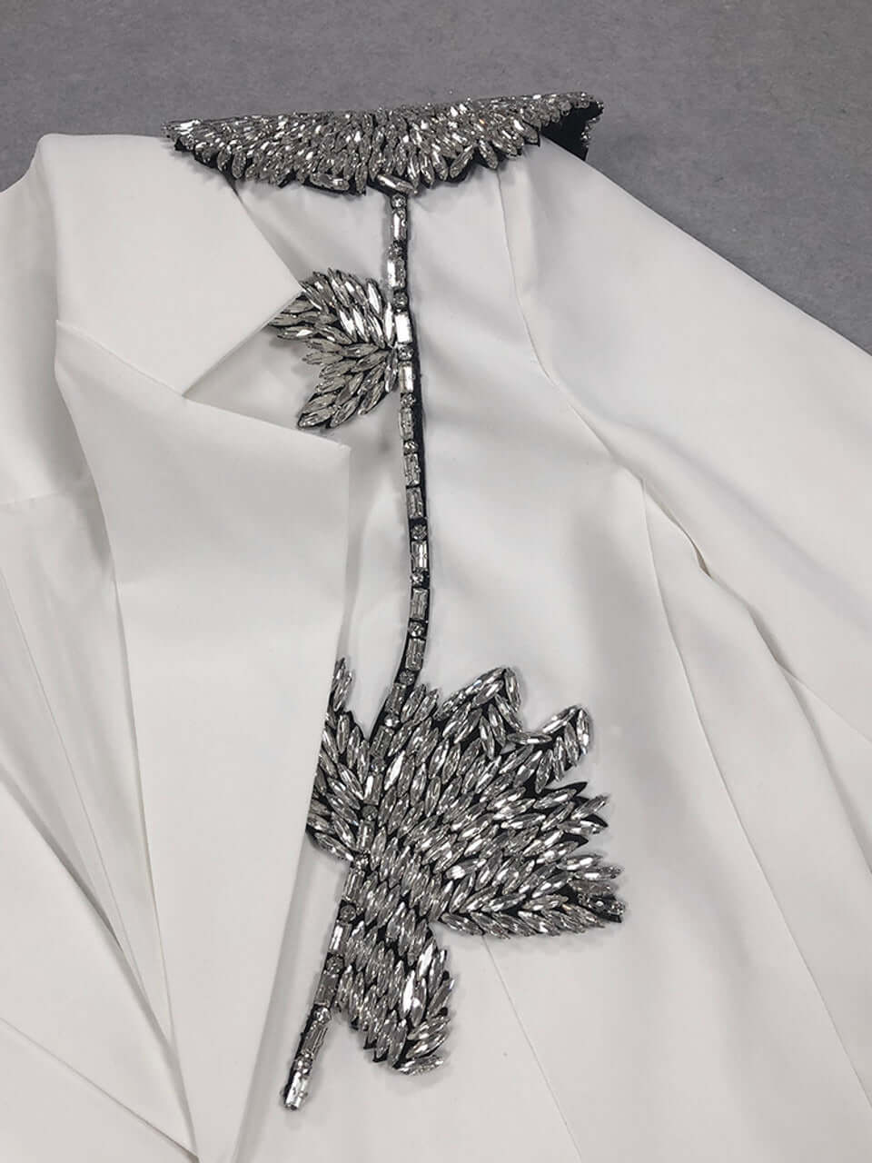 Close-up of Long Sleeve Floral Detail Blazer White with intricate floral embellishment detailing on the front pocket.