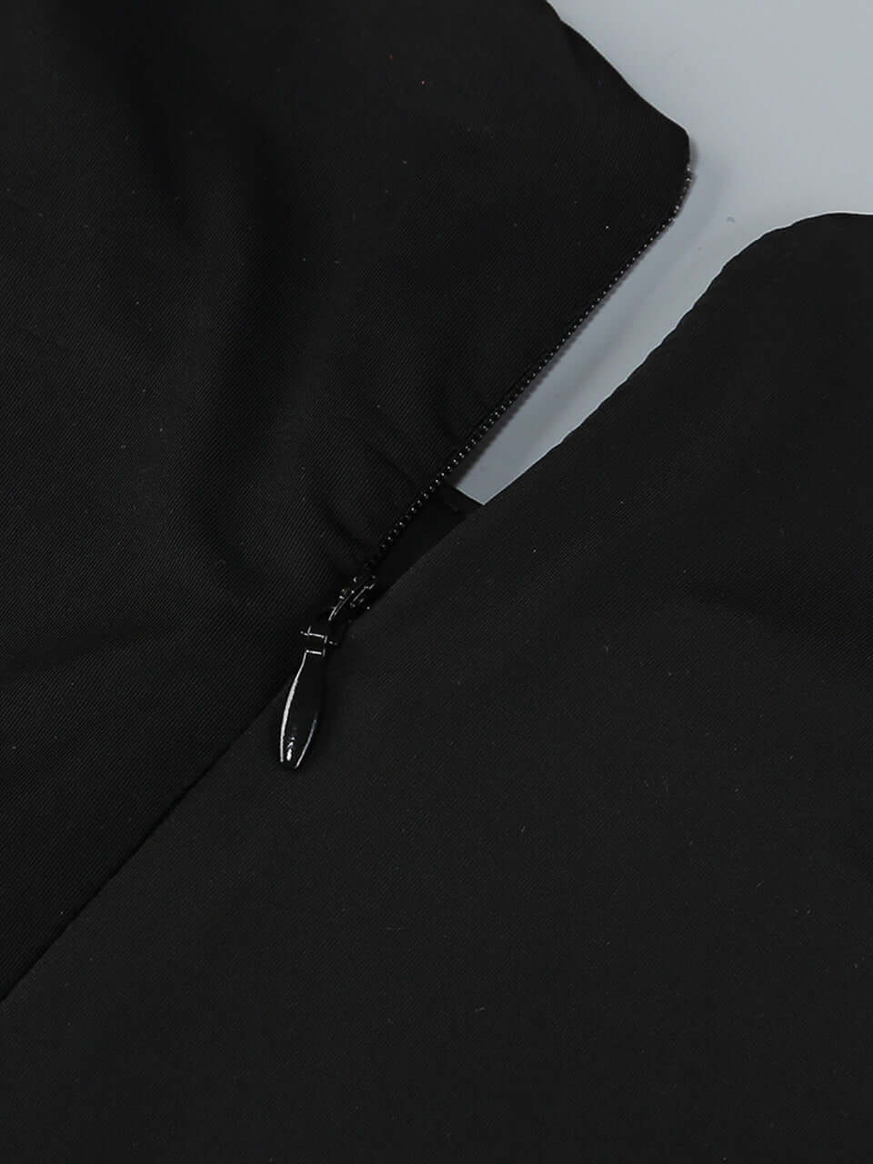 Black long sleeve mini dress with crystal embellishments and draped neckline for formal events
