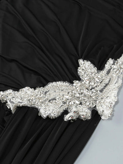 Black long sleeve mini dress with crystal embellishments and draped neckline for formal events