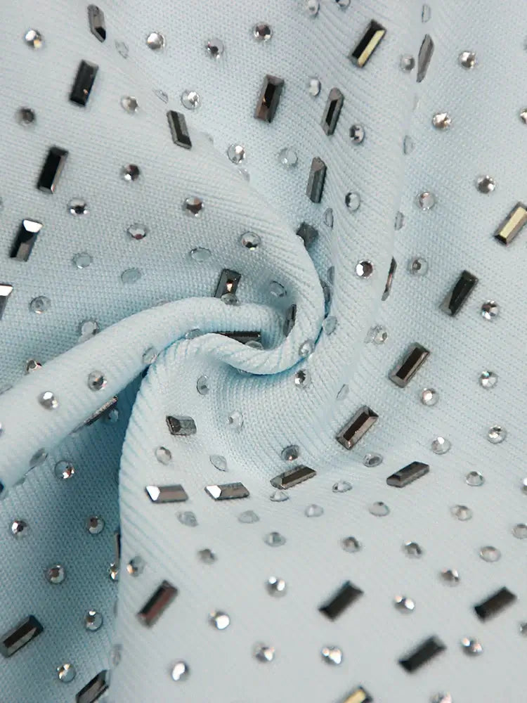 Hollow Out Embellished Mini Dress In Light Blue close-up showing intricate hollow-out embellishments and fabric details.