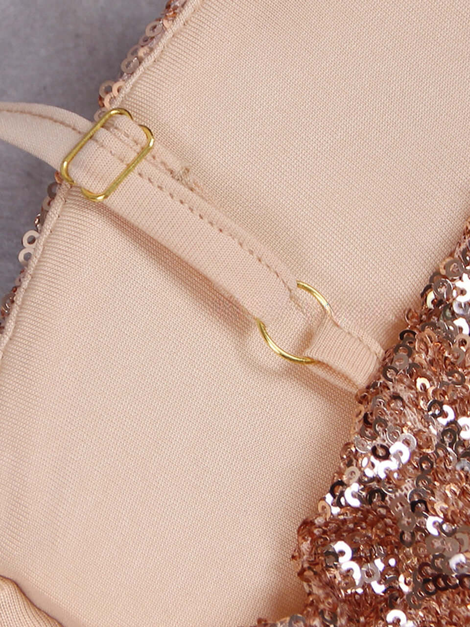 Stunning golden jumpsuit with spaghetti straps, adorned with sequins, and featuring a coordinating belt for added glamour.