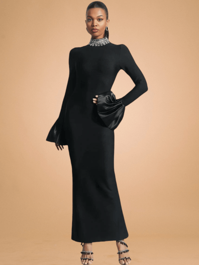 A stylish woman showcasing a sophisticated flare long-sleeve high-neck maxi dress accentuated with a sparkling diamante bandage design