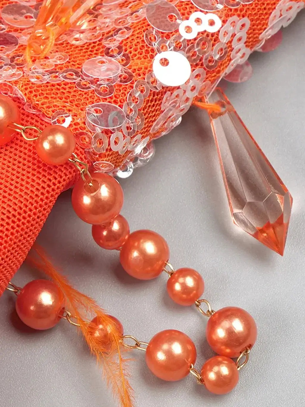 Flowing orange maxi dress from Noura Couture adorned with pearls