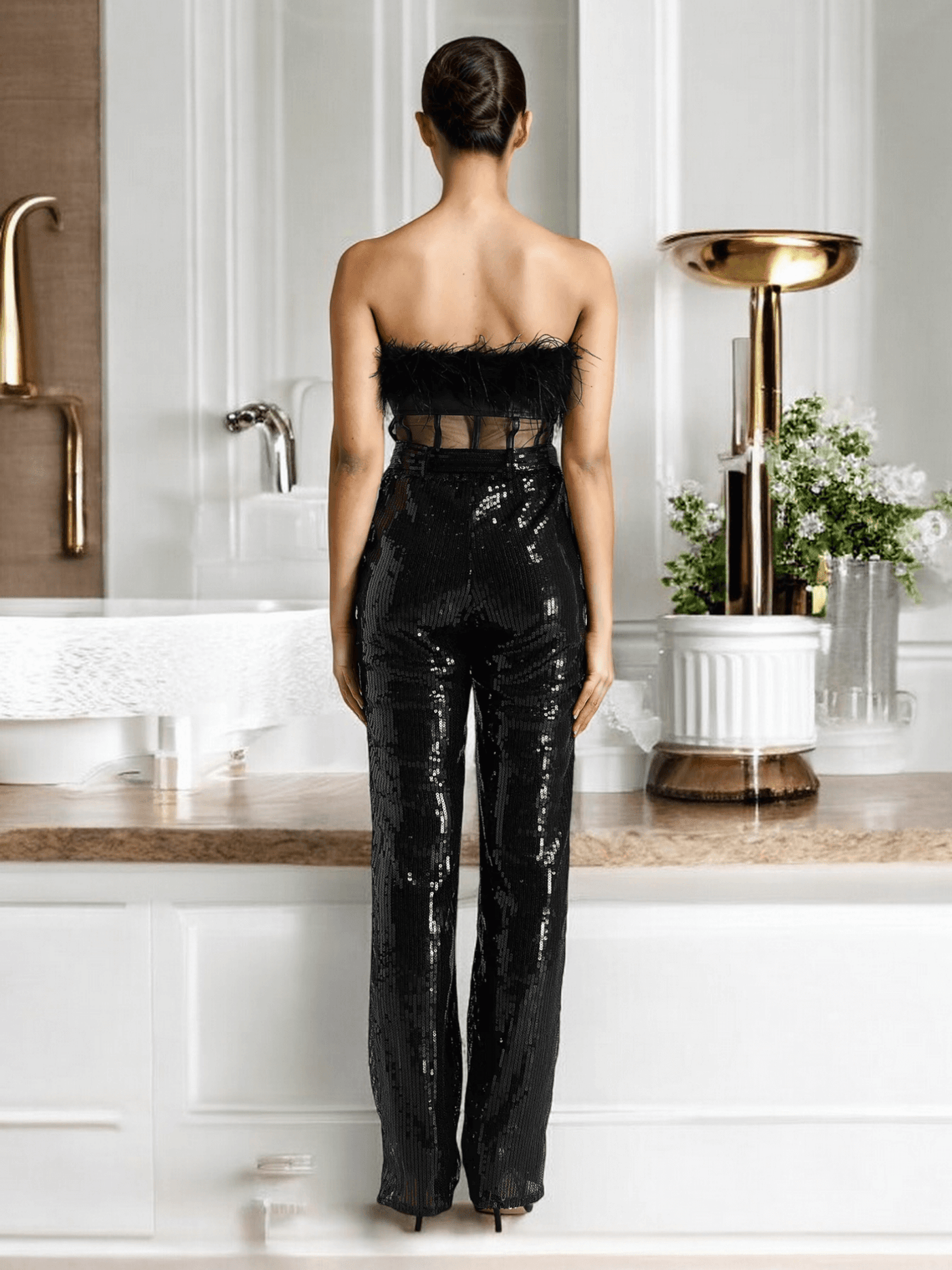 Black strapless jumpsuit with feather and sequin details