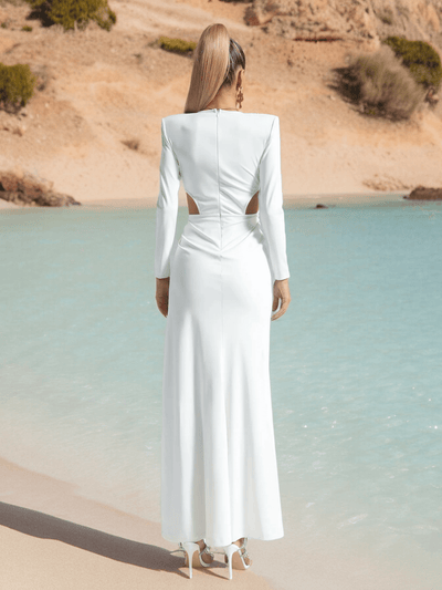 Back view of High Split White Maxi Dress in viscose fabric at a beachside.