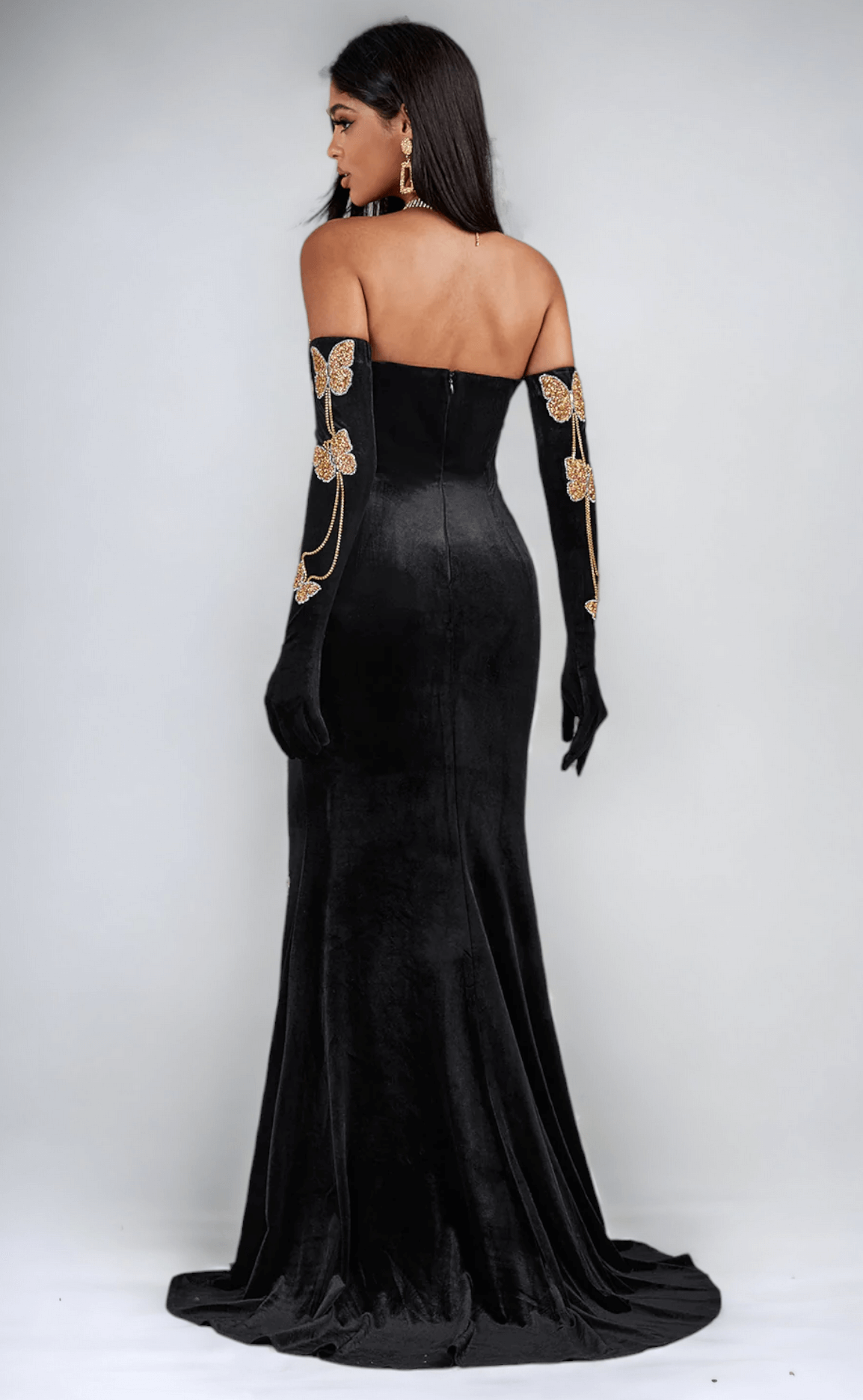 Maxi dress crafted from velvet fabric, adorned with a charming butterfly chain embellishment