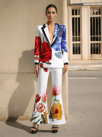 Woman wearing Floral Printed Blazer Set with vibrant flower designs, standing outdoors against a neutral background