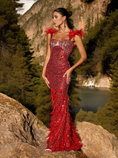 Woman wearing Red Glitter Sequins Maxi Dress posing outdoors in front of scenic mountain and forest backdrop.